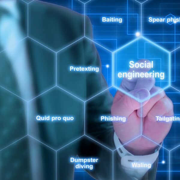 A person in a suit points to a virtual hexagonal grid highlighting social engineering and cybersecurity threats like phishing, baiting, tailgating, pretexting, and dumpster diving.