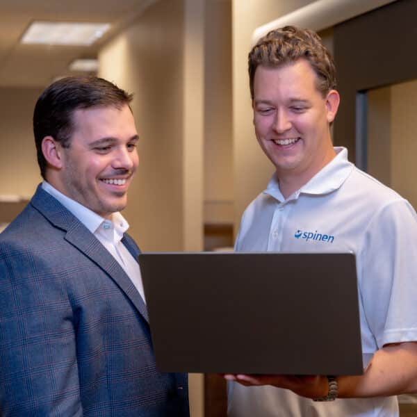 An IT strategy partner at Spinen consulting with someone in the office.